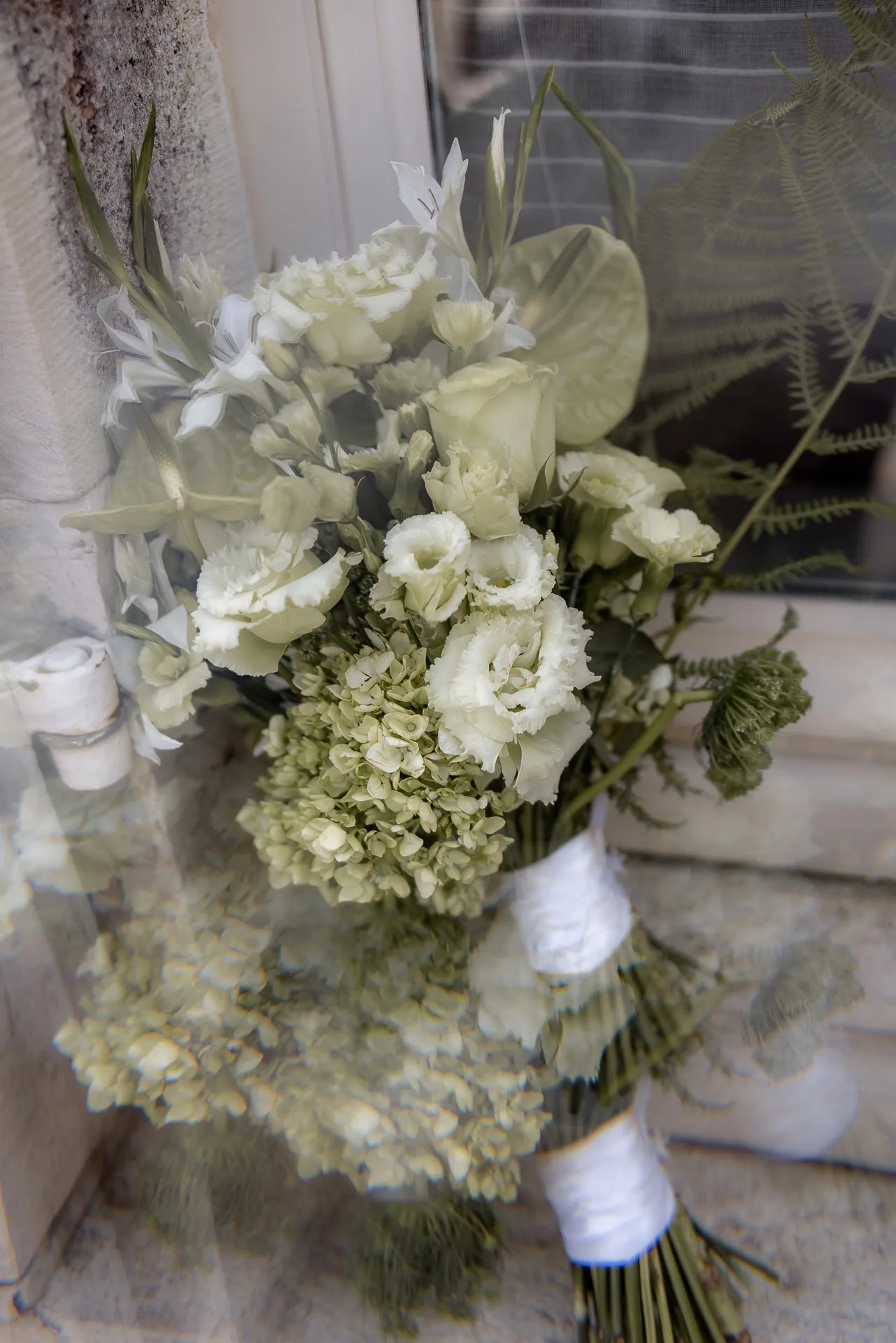 Elegant white bridal bouquet with roses and hydrangeas at luxury wedding at Chateau de Varennes